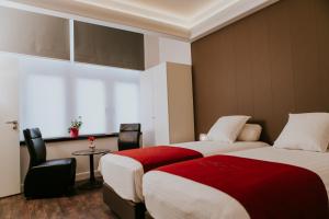 Ένα ή περισσότερα κρεβάτια σε δωμάτιο στο Hotel New Regina