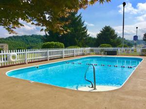 a large swimming pool with a white fence at Motel 6-Hillsville, VA in Hillsville