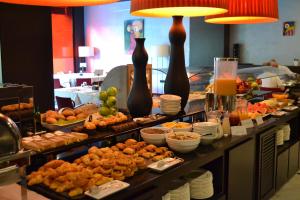 a buffet line with many different types of food at URH Ciutat de Mataró in Mataró +35 photos