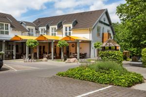 a building with yellow umbrellas on a street at Hotel Waldesrand in Herford