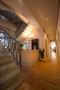 a hallway of a building with stairs and a counter at Locanda Ca&rsquo; Rossa in San Giovanni in Croce