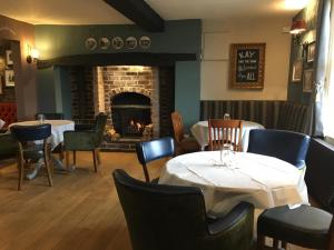 a restaurant with two tables and a fireplace at The Angel Inn Stourport in Stourport