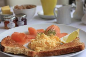 a plate of breakfast food with eggs and toast at Woodlands in Windermere