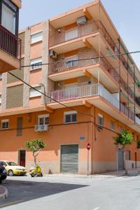 pomarańczowy budynek z balkonem na boku w obiekcie Miro w mieście El Campello