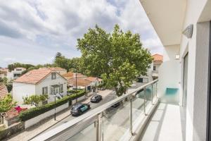 an apartment balcony with a view of a street at modern flat in Estoril