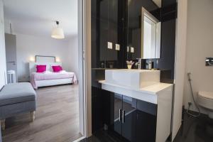 a bathroom with a sink and a bedroom with a bed at modern flat in Estoril