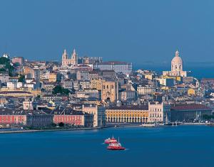 a view of a city with a boat in the water at modern flat in Estoril