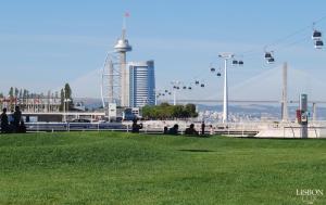a group of people sitting on a park with a chair lift at modern flat in Estoril