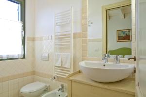 a bathroom with a white sink and a toilet at L'Orso e L'Ape B&B in Giulianova