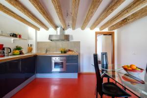 a kitchen with a glass table and blue cabinets at The Lion's House APT4 in Venice