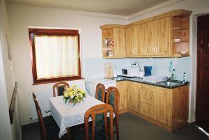 A kitchen or kitchenette at Kertész Apartmanok