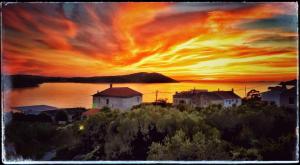 a painting of a sunset over a body of water at Guesthouse Villa Ljubica in Soline