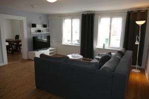 a living room with a couch and two windows at Ferienwohnung am Markt in Biesenthal