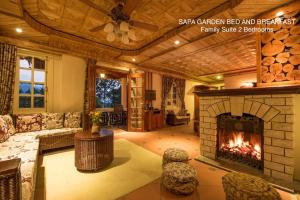 a living room with a fireplace and a couch at Sapa Garden Bed and Breakfast in Sapa