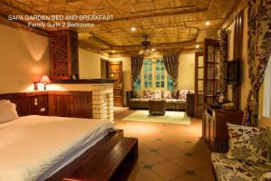 a bedroom with a bed and a living room at Sapa Garden Bed and Breakfast in Sa Pa