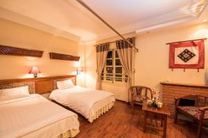 Posteľ alebo postele v izbe v ubytovaní Thai Binh Sapa Hotel