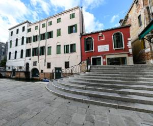 a set of stairs in a city with buildings at Casetta Rossa in Venice