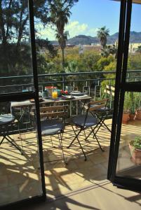 a table and chairs on a balcony with a view at THE BOHO-CHIC OASIS, lovely city center apartment in Málaga