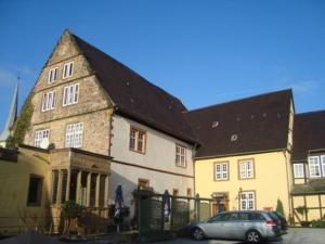 a car parked in front of a large house at Hotel Stadtpalais in Lemgo