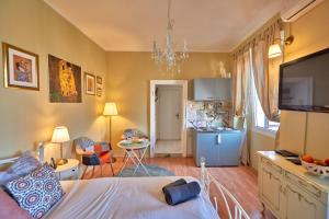 a bedroom with a bed and a living room with a kitchen at Old City Romantic Studio with FREE private parking in Pula