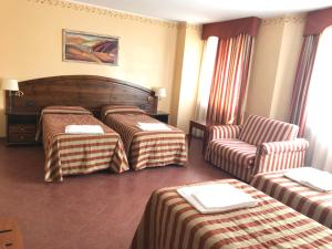 Postel nebo postele na pokoji v ubytování Hotel Relais Des Alpes