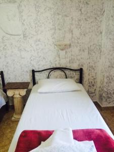 a bedroom with a bed with a red blanket on it at Sweet Home in Karterados