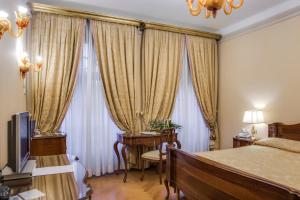 A bed or beds in a room at Villa Fenaroli Palace Hotel