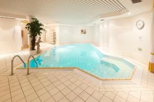 a large swimming pool in a building at Hotel Kastanienhof in Bad Münder am Deister