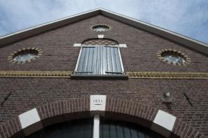 a tall brick building with a window on it at Op 't Oorbeck in Enschede