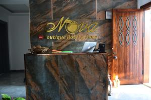a sign for a muna office hotel and more at Nova Citrus Otel in Siğacık
