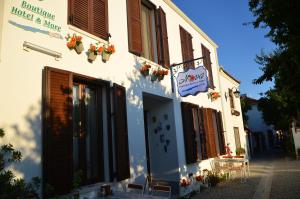 a building with a sign for a hotel and a table at Nova Citrus Otel in Siğacık +26 photos