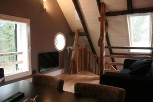 a living room with a table and a tv and stairs at Op 't Oorbeck in Enschede