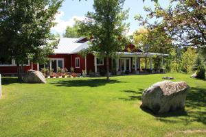 a red house with a large rock in the yard at Pleasant Valley in Rice