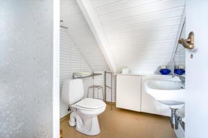 a bathroom with a toilet and a sink at Grand Villa Stavanger in Stavanger +47 photos