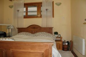 a bedroom with a wooden bed and a window at Paradise Corner in Pomorie