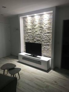 a living room with a flat screen tv on a tv stand at Flaminia Wohnung 15 in Leukerbad