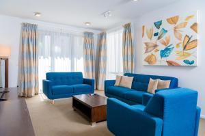 a living room with two blue couches and a table at Boulcott Suites in Wellington