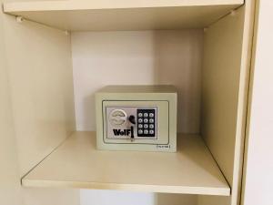 a microwave in a shelf in a drawer at Helen Apartment in Tel Aviv