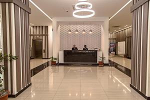 a lobby with two men standing at a counter at Sierra Palms Resort in Freetown