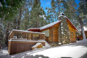 a log cabin in the woods in the snow at 16 Chipmunks Holiday in Wawona