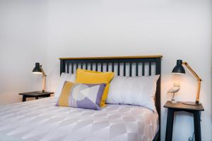 a bedroom with a bed with two lamps on tables at Albury Yalandra Apartment 4 in Albury