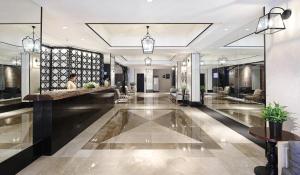 a lobby of a hotel with a reception desk at Manila Lotus Hotel in Manila