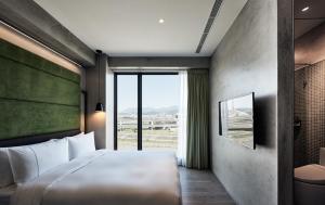 a bedroom with a large bed and a large window at Waterfront Hotel in Taipei +43 photos