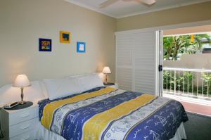 a bedroom with a bed and a large window at Bright & comfortable in quiet location in Sunshine Beach