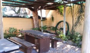 a picnic table and bench under a pergola at Bordertown Motel in Bordertown