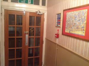a door in a building with a map on the wall at Victoria Hotel Blackpool in Blackpool +2 photos