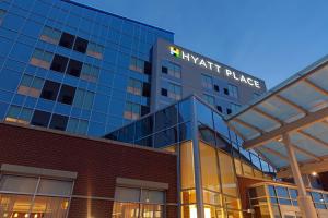 a large building with a clock on the front of it at Hyatt Place Chicago Midway Airport in Bedford Park