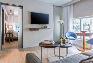 
a living room filled with furniture and a tv at Hyatt Centric South Beach Miami in Miami Beach

