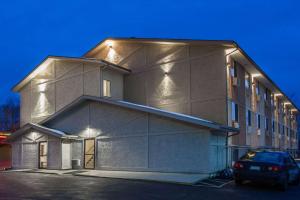 a building with a car parked in front of it at Super 8 by Wyndham Dubuque in Dubuque