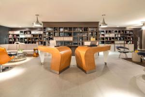 a living room with a couch and a table and chairs at Hyatt Centric South Beach Miami in Miami Beach